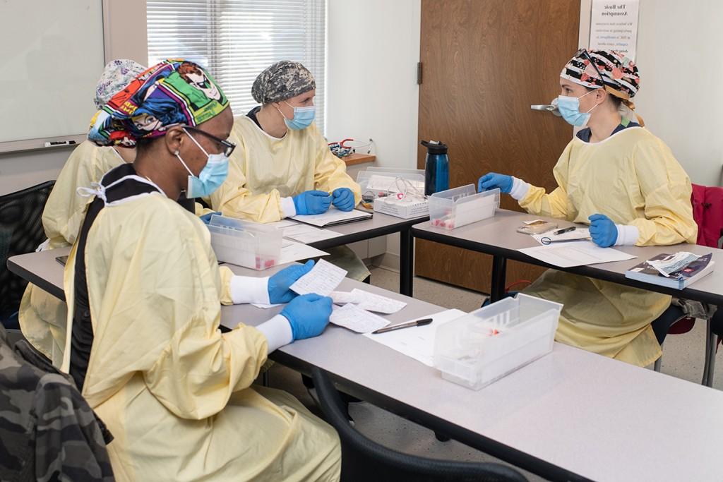 Four nursing anesthesia students sitting in a classroom